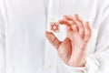 Male hand holds a wooden cube with Star of David symbol. Judaism and Israel