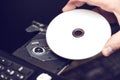 Male hand inserting a DVD into a disk drive. Software or drivers installation concept Royalty Free Stock Photo