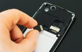 Male hand inserting Micro SD.