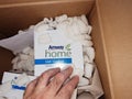 Male hand inside the parcel with Amway detergents goods - online e-commerce