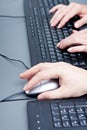 Male hand on keyboard typing and scroll mouse Royalty Free Stock Photo