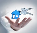 Male hand with keys and a house shaped key chain Royalty Free Stock Photo