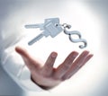 Male hand with keys and a paragraph shaped key chain Royalty Free Stock Photo