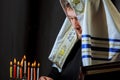 male hand lighting candles in menorah on table Hanukkah Royalty Free Stock Photo