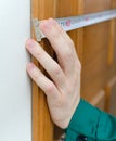Male hand measuring door