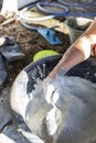 Male hand mixing cement, construction site Royalty Free Stock Photo