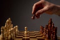 Male hand moving pawn on chess board, starting game. Making business decision concept Royalty Free Stock Photo
