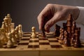 Male hand moving pawn on chess board, starting game. Making business decision concept Royalty Free Stock Photo