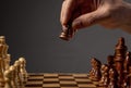 Male hand moving pawn on chess board, starting game. Making business decision concept Royalty Free Stock Photo