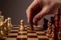 Male hand moving pawn on chess board, starting game. Making business decision concept Royalty Free Stock Photo