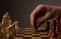 Male hand moving pawn on chess board, starting game and making first step. Making business decision concept