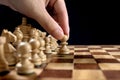 Male hand moving the white chess pawn during the game of chess Royalty Free Stock Photo