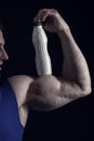 Male hand of muscular man with biceps, triceps, drink bottle Royalty Free Stock Photo