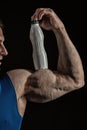 Male hand of muscular man with biceps, triceps, drink bottle Royalty Free Stock Photo