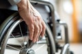 male hand navigating a wheelchair, portraying the everyday reality of physical limitations