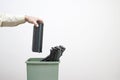 Male hand office worker puts in a bucket of spent cartridges. Background