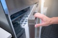 Male hand opening fridge or refrigerator door in kitchen Royalty Free Stock Photo