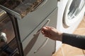 Male hand opening kitchen cupboard door Royalty Free Stock Photo