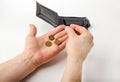 Male hand opening a wallet and count coins money on white background. World economic crisis. Financial problem jobless, Royalty Free Stock Photo