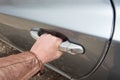 Male hand opens the car door with inner handle