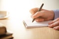 The male hand with a pen and the cup Royalty Free Stock Photo