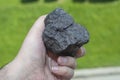 Male hand with a piece of coal Royalty Free Stock Photo