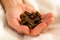 Male hand with pills on a bed. Drug overdose concept Royalty Free Stock Photo