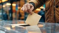 Male hand placing ballot into voting box at polling station. Mature man voting. Voter. Concept of democracy, election Royalty Free Stock Photo