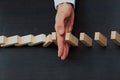 Male hand placing wooden block on a tower. planing and strategy concept. Royalty Free Stock Photo