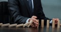 Male hand placing wooden block on a tower. planing and strategy concept. Royalty Free Stock Photo