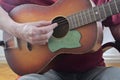 Male hand playing on acoustic guitar. Close-up. Musical concept Royalty Free Stock Photo