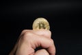 Male hand playing with golden Bitcoin Royalty Free Stock Photo