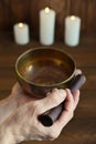 Male hand playing on Tibetan handcrafted singing bowls