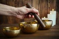 Male hand playing on Tibetan singing bowls