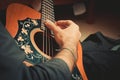 The male hand plays the strings of the old guitar close-up Royalty Free Stock Photo