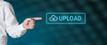 Male hand points to the word upload with icon. Cloud computer uploading