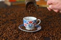 Male hand pouring Turkish coffee. cup of coffee with beans Royalty Free Stock Photo