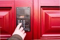 Male hand presses a button on doorbell and intercom.