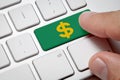 Male hand pressing green button dollar icon computer key Royalty Free Stock Photo