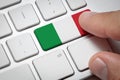 Male hand pressing keyboard key,3d render of italian flag button with soft focus Royalty Free Stock Photo