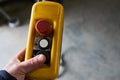 Male hand push remote control switch for overhead crane in the f Royalty Free Stock Photo