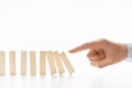 Male hand pushing dominoes on white background Royalty Free Stock Photo