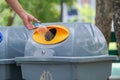 Male hand put used bottle in recycle bin