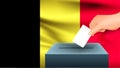 Male hand puts down a white sheet of paper with a mark as a symbol of a ballot paper against the background of the Belgium flag.