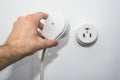 Male hand puts plug in the socket Royalty Free Stock Photo