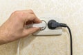 Male hand puts plug in the socket Royalty Free Stock Photo