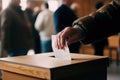 Male hand putting ballot in election box Royalty Free Stock Photo