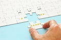 male hand putting the last piece in the puzzle. concept image of setting a five star goal. increase rating or ranking, evaluation Royalty Free Stock Photo