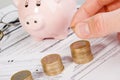 Male hand putting money on growing coin stack