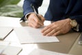 Male hand putting signature on contract, signing document, close Royalty Free Stock Photo